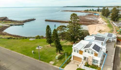 an aerial view of a house and the ocean at LegaSea Lodge - Pet Friendly Beachfront Plunge Pool in Shellharbour