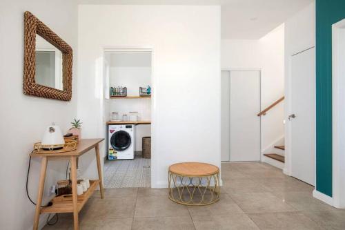 a living room with a table and a mirror at LegaSea Lodge - Pet Friendly Beachfront Plunge Pool in Shellharbour