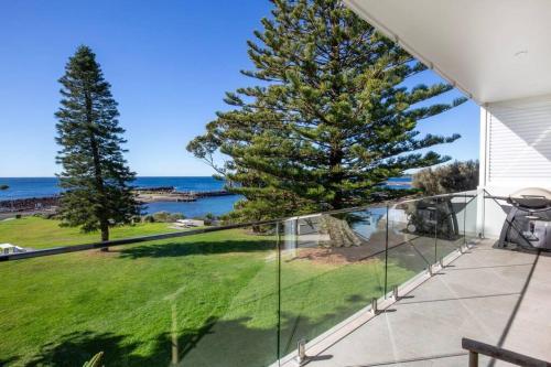 a balcony with a view of the ocean at LegaSea Lodge - Pet Friendly Beachfront Plunge Pool in Shellharbour