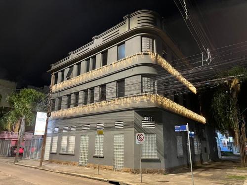 a building on a city street at night at Hotel Ivo De Conto in Porto Alegre