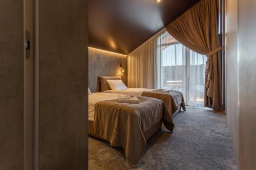 a hotel room with two beds and a window at Phoenix Medical Resort in Skhidnitsa