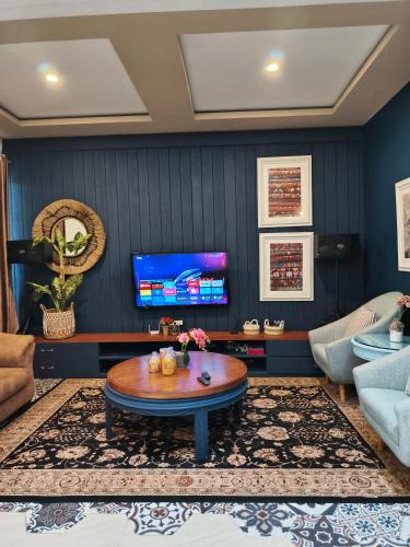 a living room with a couch and a table at Aline Villa in Wonosobo