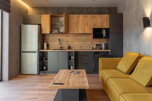 a kitchen and living room with a couch and a table at Phoenix Medical Resort in Skhidnitsa