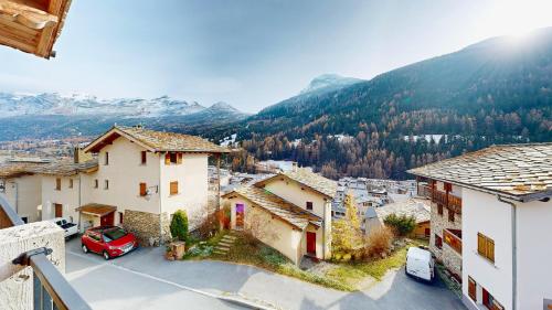 a view of a village with mountains in the background at Chalet Grand Croix - Haut Standing - 8, 10 pers in Lanslebourg-Mont-Cenis