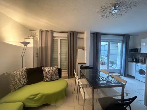 un salon avec un canapé vert et une table dans l'établissement Saint Charles, à Marseille