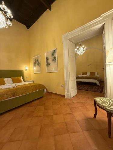 a bedroom with a bed and a table and a mirror at Palazzo Dogana Room&Suite in Salerno