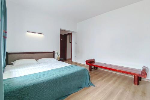 a bedroom with a large bed and a bench at Castle peak yard Inn Free railway st ation pick-up by 2 nights English and Spanish reception available in Guilin