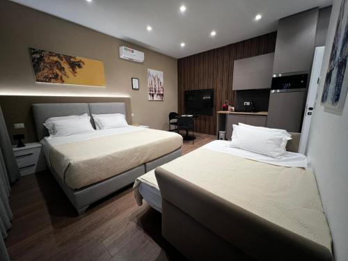 a hotel room with two beds and a television at Brianza Home in Giussano