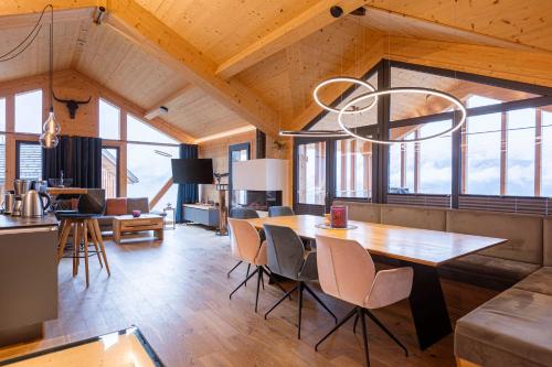 a kitchen and dining room with a table and chairs at Bergresort Hauser Kaibling by ALPS RESORTS in Haus im Ennstal
