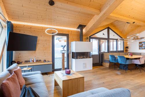a living room with a couch and a table at Bergresort Hauser Kaibling by ALPS RESORTS in Haus im Ennstal