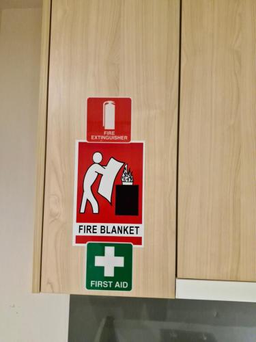 a fire alarm sign on a wooden door at Cool City 1 Bedroom in Melbourne