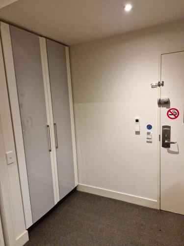 an empty room with white walls and a door at Cool City 1 Bedroom in Melbourne