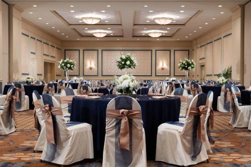 a banquet hall with tables and chairs in a room at Francis Marion Hotel in Charleston