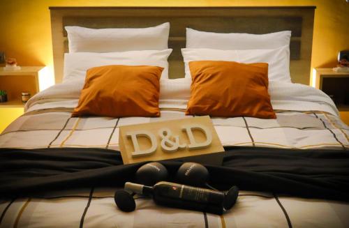 a bed with a pile of pillows and a sign on it at D&D rooms Nafplio in Nafplio