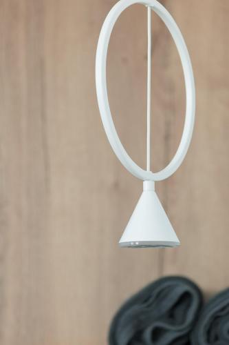 a white mirror hanging on a wall at Karat Suites in Vóthon