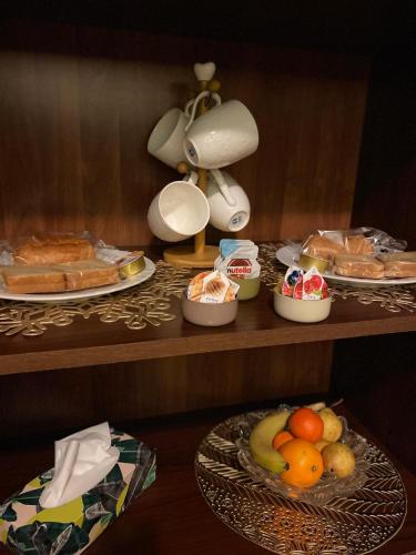 a table with plates of food on a shelf at GiGiRo-om in Fiumicino