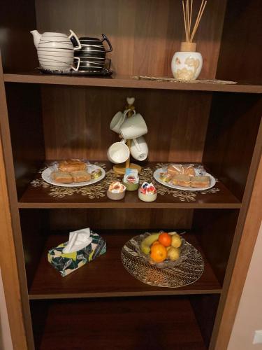 a cupboard with plates of food and a telephone at GiGiRo-om in Fiumicino
