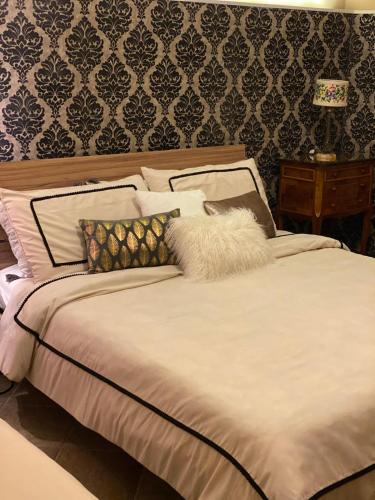 a bedroom with a bed with pillows on it at GiGiRo-om in Fiumicino