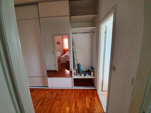 a large mirror in a room with a bedroom at Apartments Laus in Dubrovnik