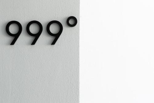 a white wall with black numbers on it at Karat Suites in Vóthon
