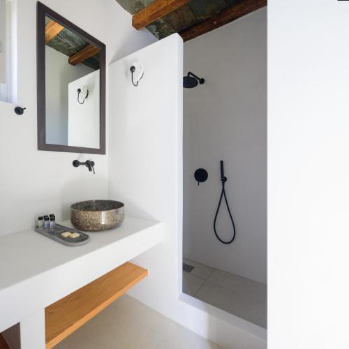 a bathroom with a sink and a mirror at Seascape Suites Folegandros in Ano Meria
