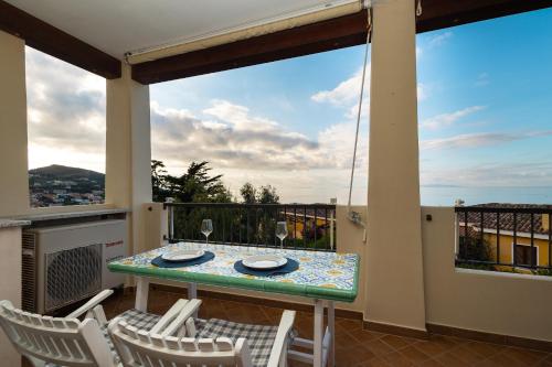 a patio with a table and chairs on a balcony at CASTELSARDO Casa Raoul Piscina e vista mare in Castelsardo