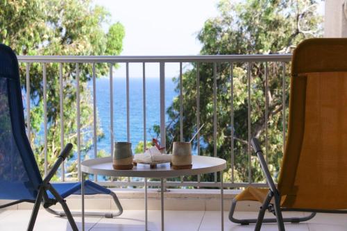 a table and chairs on a balcony with a view of the ocean at Freshness Modern 2 Bedroom Apartment with Balcony & Stunning Sea View in Central Limassol in Limassol