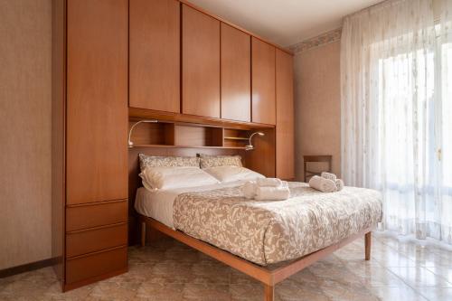 a bedroom with a large bed with a wooden headboard at Garden - residence in the center of Barzio in Barzio