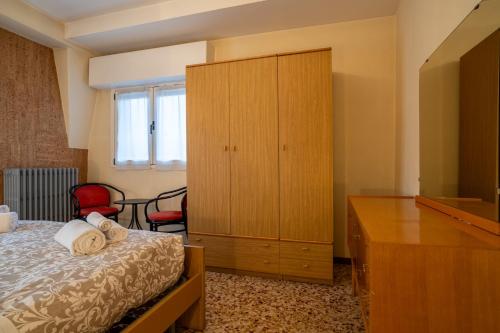 a bedroom with a bed and a cabinet and a dresser at Garden - residence in the center of Barzio in Barzio