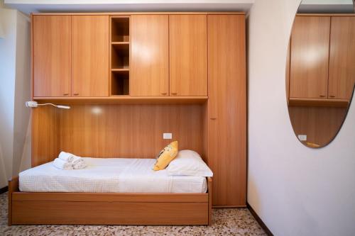 a small bedroom with a bed and a mirror at Garden - residence in the center of Barzio in Barzio