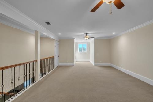 a hallway of a home with a ceiling fan at Luxurious 4-Bedroom Oasis with Private Pool in Seguin