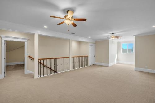 an empty living room with a ceiling fan at Luxurious 4-Bedroom Oasis with Private Pool in Seguin