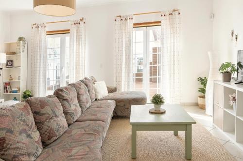 a living room with a couch and a table at Casa da Barragem in Atouguia da Baleia
