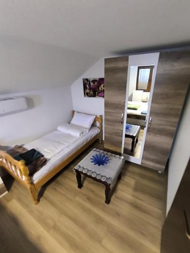 a small room with a bed and a mirror at Mountain House - Brezovica in Brezovicë
