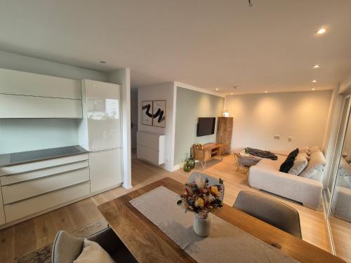 a living room with a couch and a table at FeWo Bodensee Base in Rielasingen-Worblingen