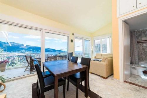 a living room with a table and chairs and a couch at Villa Andrea in Skala Potamias