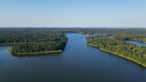 an aerial view of a large lake with islands at Dom Na Brzegu Ciszy in Pasym