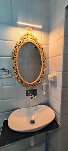 a bathroom with a sink and a mirror at The Brahmin's Homestay in Jodhpur