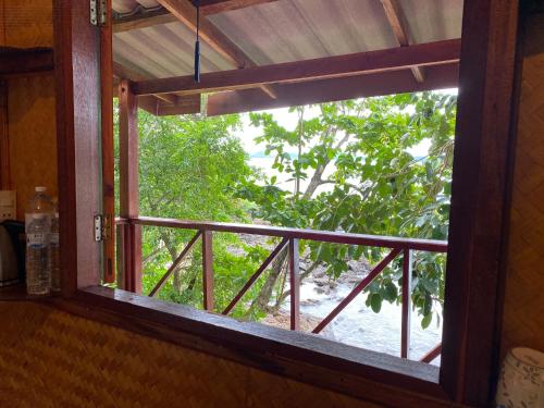 an open window with a view of a tree at KoyAo Bungalows in Trang