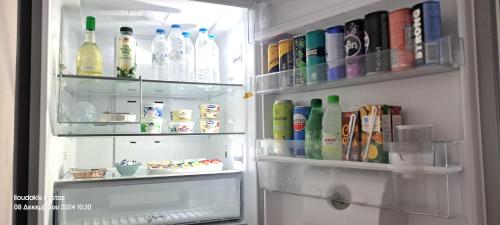 an open refrigerator filled with lots of drinks at Zoe garden home in Spáta