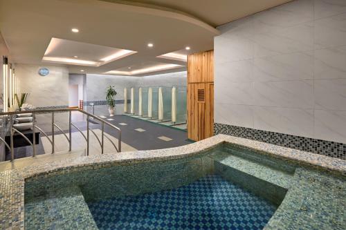 a swimming pool in the middle of a building at The Hanoi Club Hotel & Residences in Hanoi