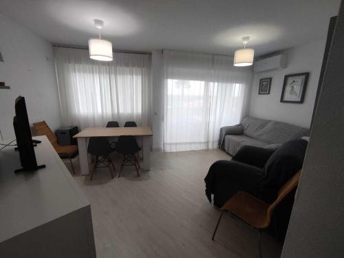 a living room with a couch and a table at Apartamento Sol y Brisa in Matalascañas