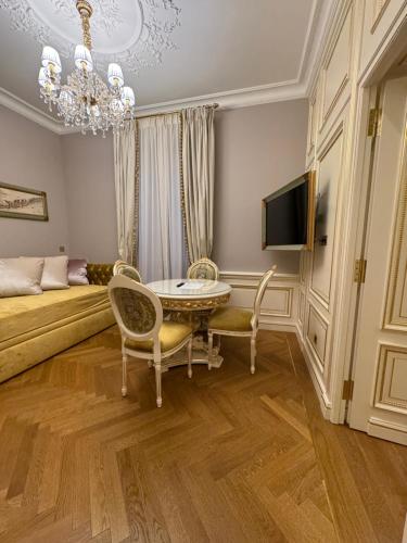 a living room with a bed and a table and chairs at Maison des Barons in Nice