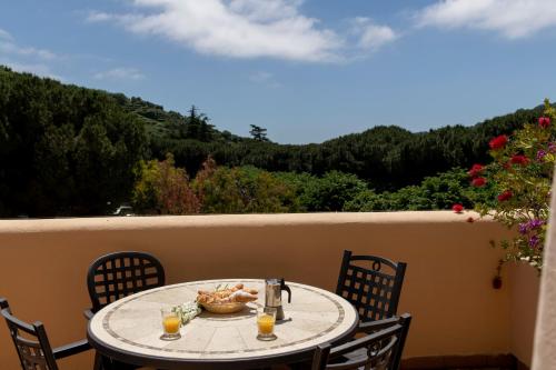 a table with a plate of food on a balcony at Il Villaggio Di Giuele in Finale Ligure