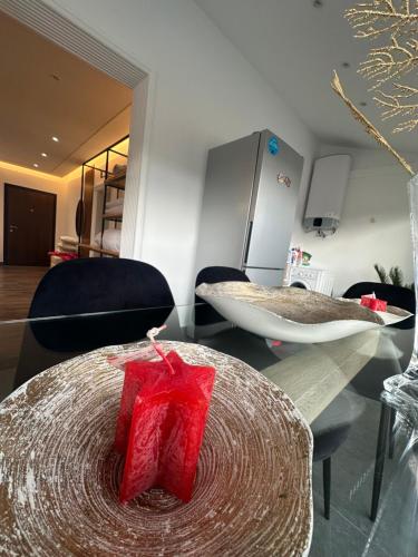 a room with a table with a red present on it at My Sky Përmet in Përmet