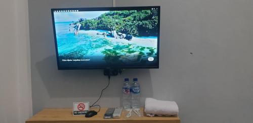 a flat screen tv hanging on a wall at Han Gang Syariah in Ponorogo