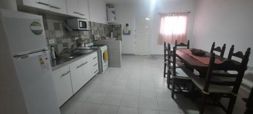una cucina con tavolo, sedie e frigorifero di Lucero del Ibera a Mercedes