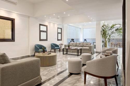 a living room with couches and chairs at Mynt Residence New Cairo one bedroom in Cairo