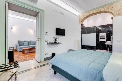 a bedroom with a blue bed and a couch at Navona Queen Rooftop in Rome