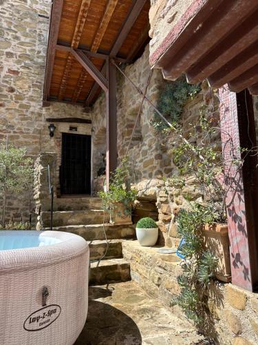 an outdoor bath tub sitting in a stone building at Castello di Francocci Spoleto in Marzolini